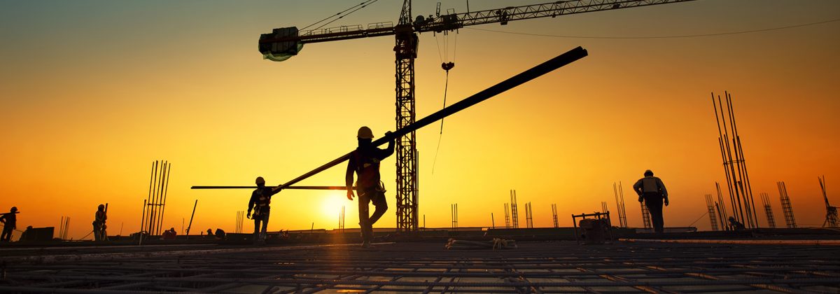 Silhouette construction workers fabricating steel reinforcement bar at the construction site